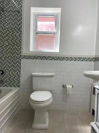 a bathroom with a toilet a sink and a bathtub