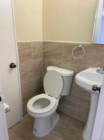 a white toilet sitting next to a bathroom sink