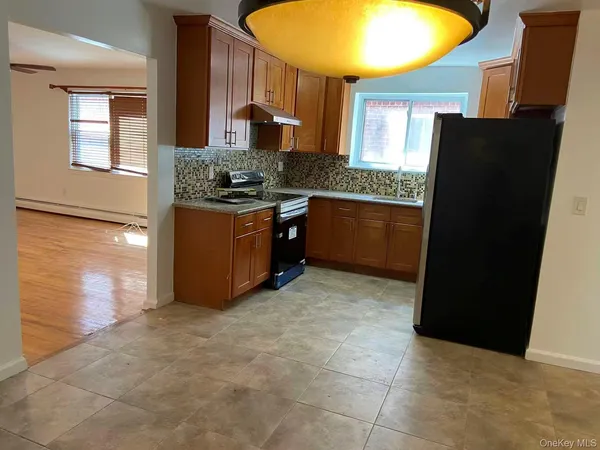 a kitchen with stainless steel appliances granite countertop a refrigerator and a stove
