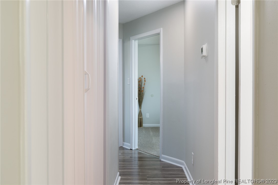 4514 Ruby Road Fayetteville, NC 28311 - Photo 11 of 21 a view of a hallway with wooden floor and staircase