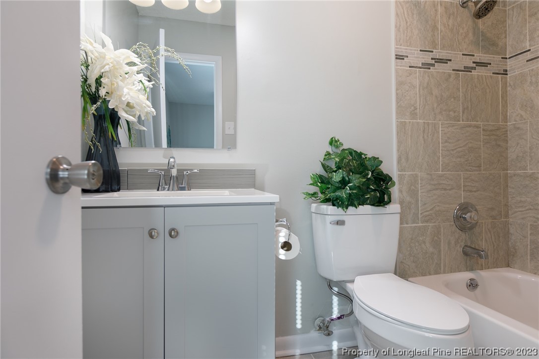 4514 Ruby Road Fayetteville, NC 28311 - Photo 18 of 21 a bathroom with a sink a toilet and shower