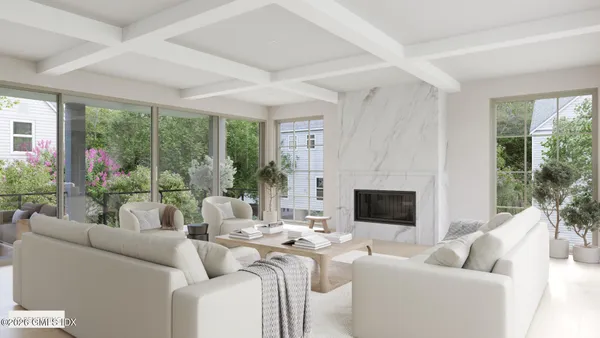 a living room with furniture a large window and a flat screen tv