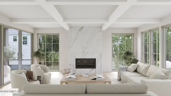 a living room with furniture tv and large window