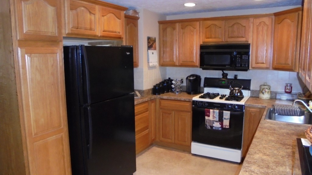 108 Wyman Road Billerica, MA 01821 - Photo 3 of 21 a kitchen with stainless steel appliances granite countertop a refrigerator and a stove top oven
