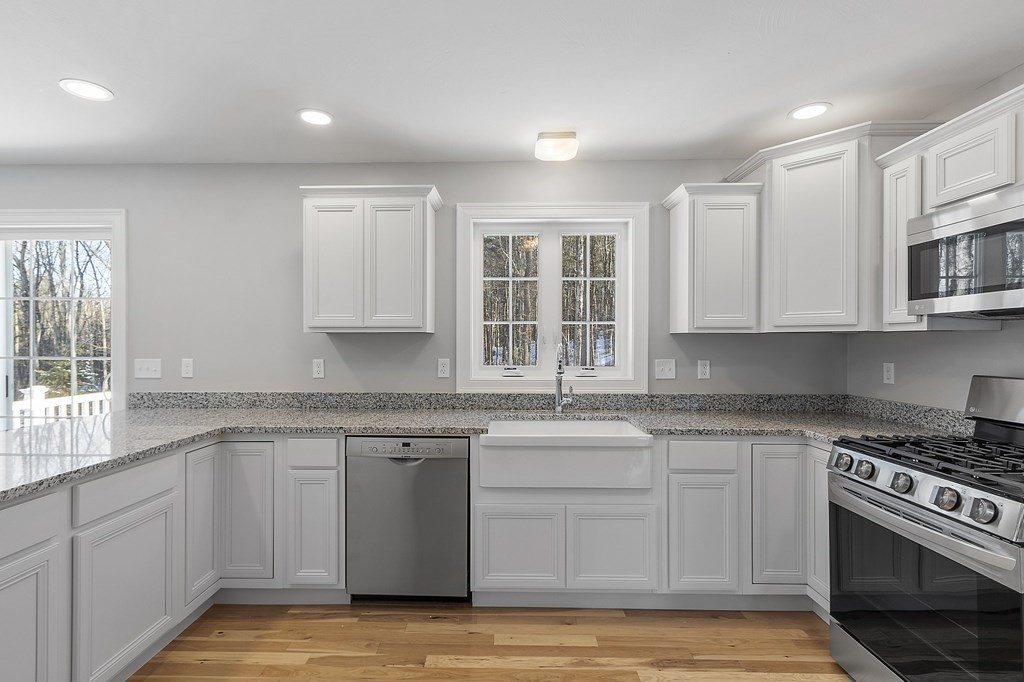 156 French Road, Unit LOT 5 Templeton, MA 01468 - Photo 13 of 39 a kitchen with stainless steel appliances granite countertop a stove a sink and white cabinets