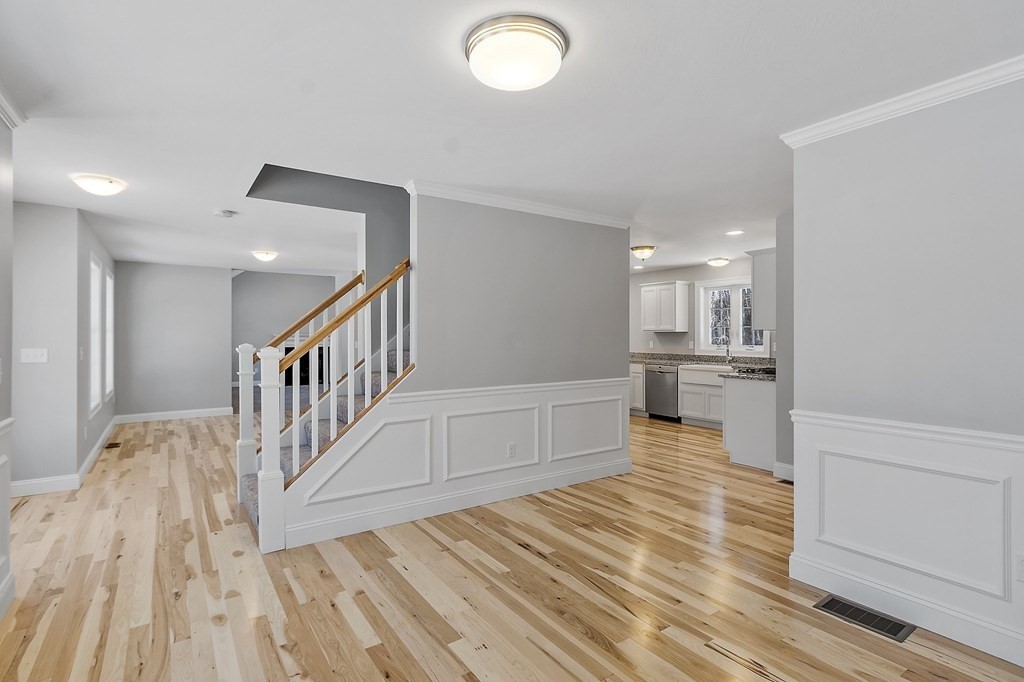156 French Road, Unit LOT 5 Templeton, MA 01468 - Photo 17 of 39 a view of a hallway with wooden floor and a kitchen