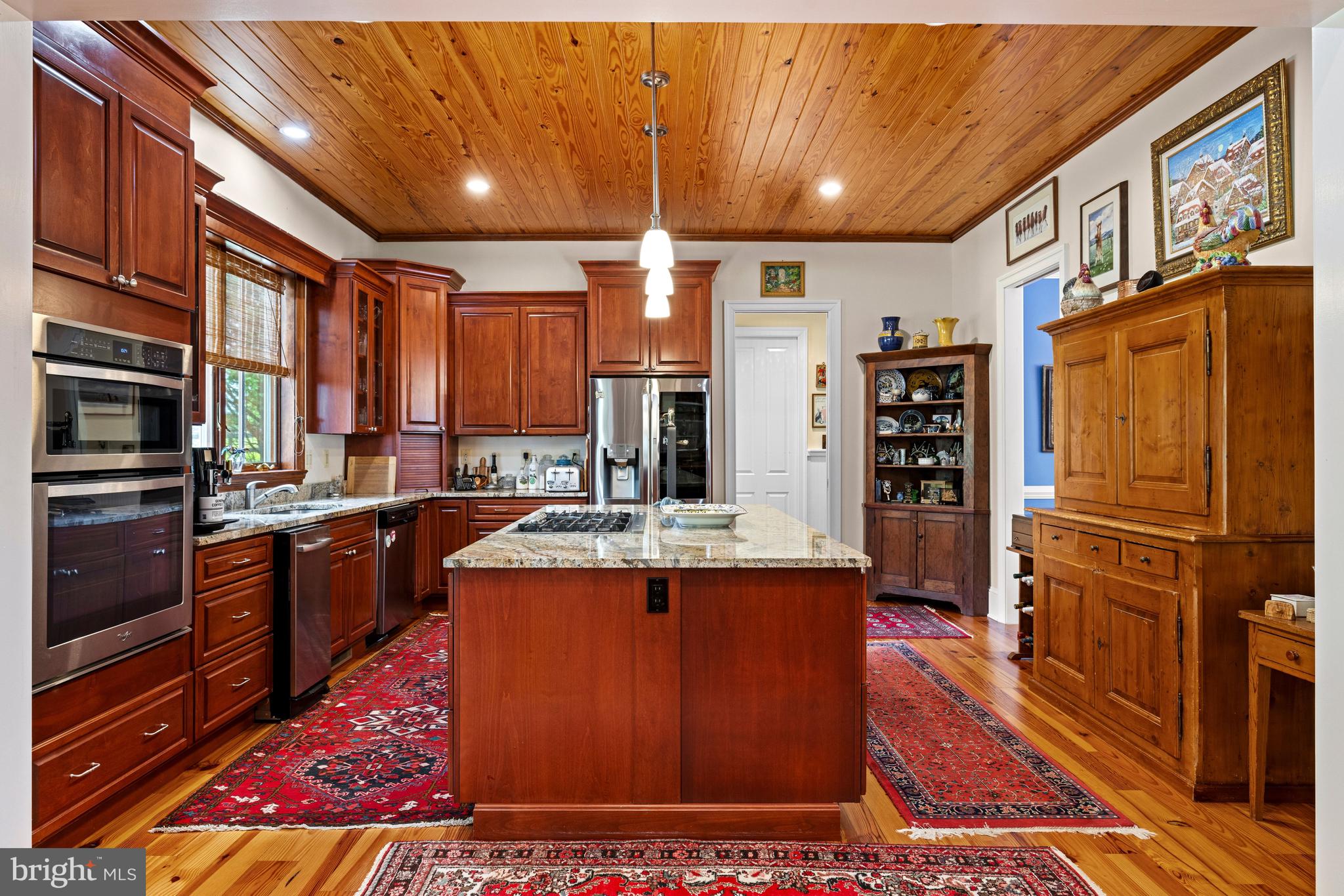 20147 Woodtrail Road Round Hill, VA 20141 - Photo 15 of 41 a large kitchen with stainless steel appliances granite countertop a stove a sink dishwasher and cabinets with wooden floor