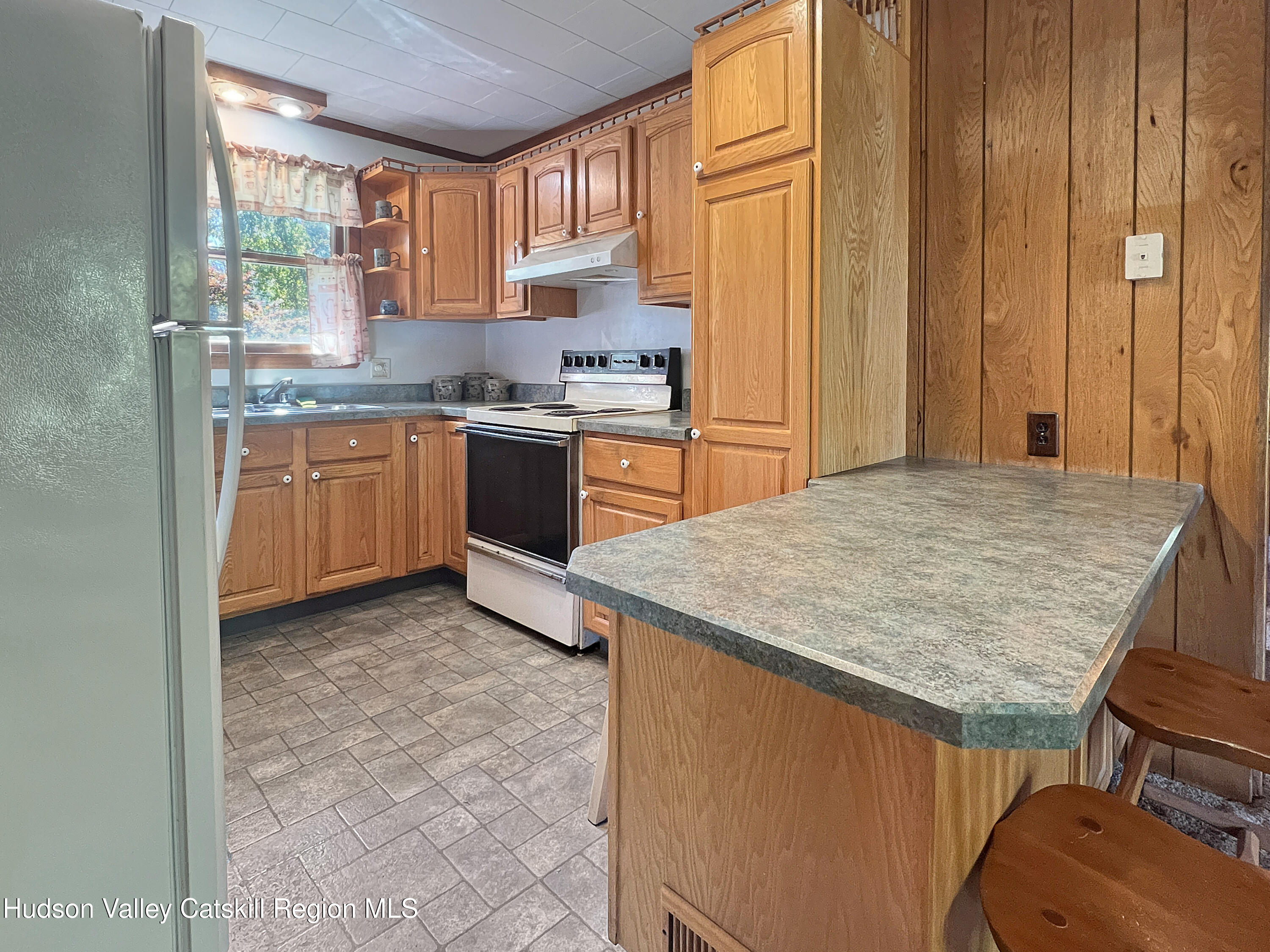 1076 Lakeview Road Copake, NY 12516 - Photo 8 of 19 a kitchen with stainless steel appliances granite countertop a sink stove and cabinets