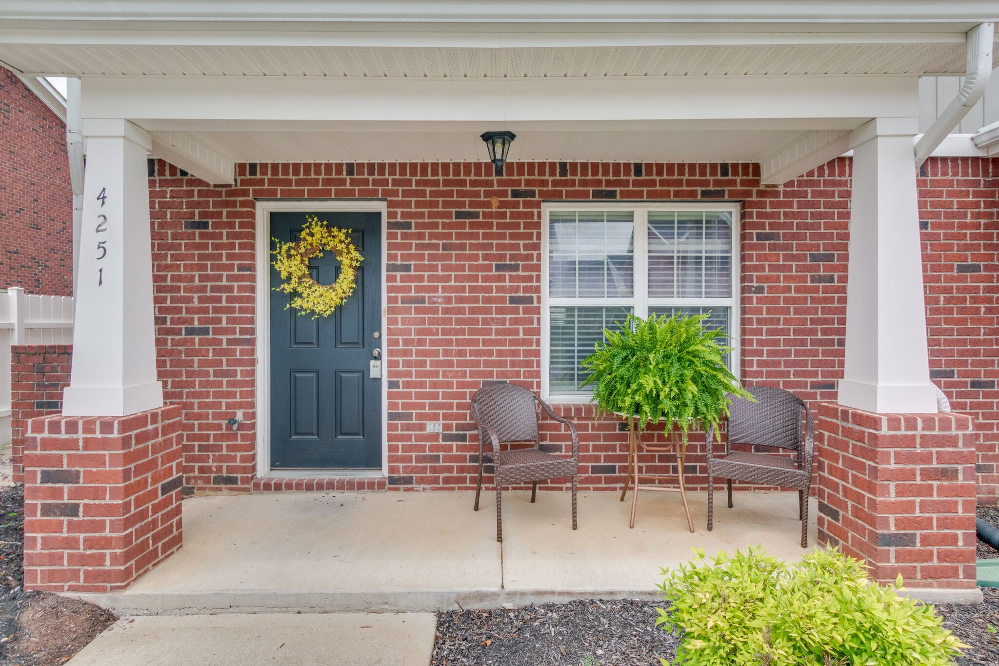 4251 Aurora Circle Murfreesboro, TN 37127 - Photo 2 of 11 a house with a bench and potted plants