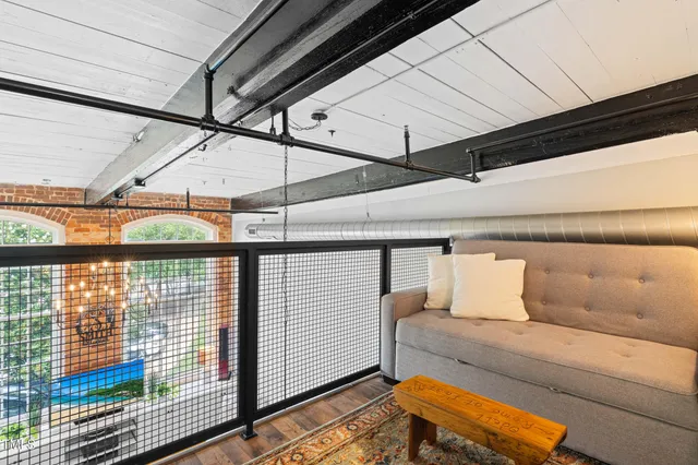 a bed sitting in a bedroom next to a window