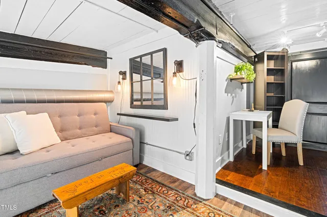 a bedroom with bed and a chandelier