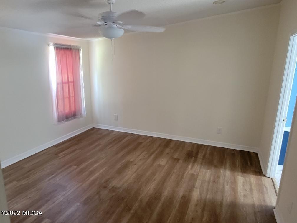 4460 Fulton Mill Road Macon, GA 31216 - Photo 12 of 23 wooden floor in an empty room with a window