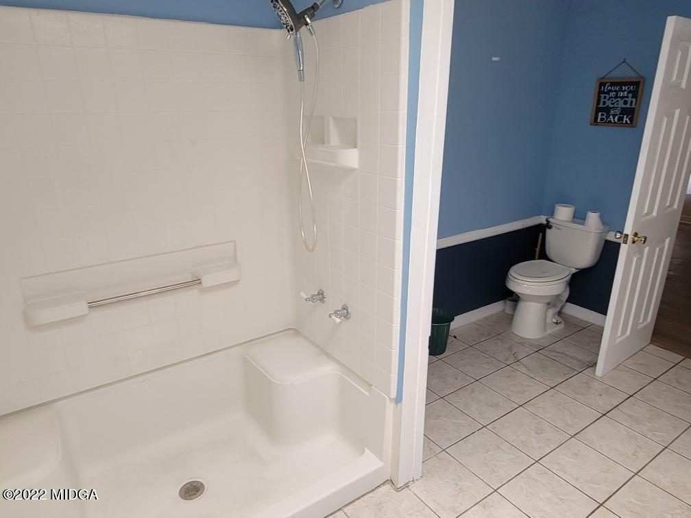 4460 Fulton Mill Road Macon, GA 31216 - Photo 14 of 23 a bathroom with a toilet and a shower