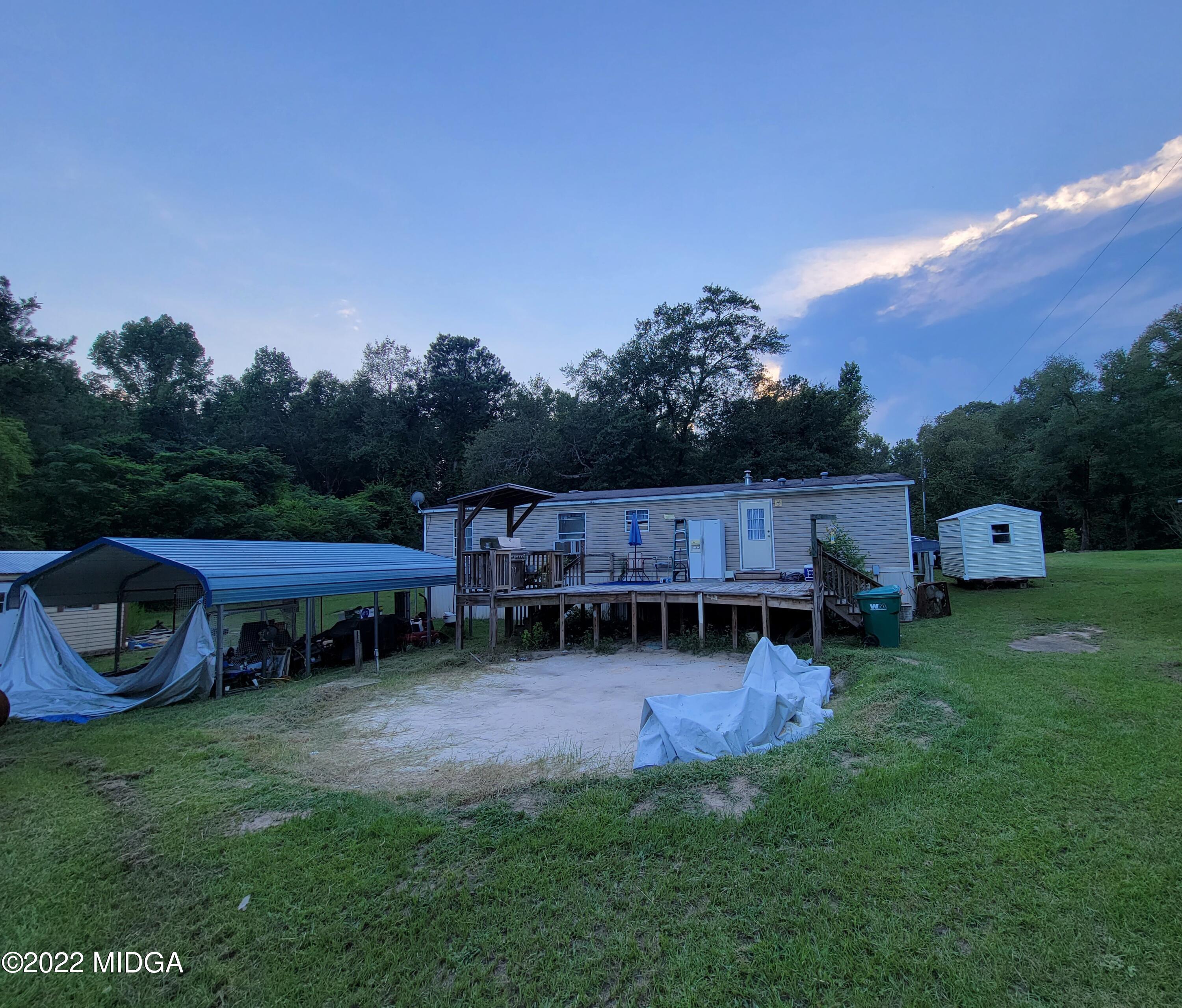 4460 Fulton Mill Road Macon, GA 31216 - Photo 16 of 23 a backyard of a house with table and chairs