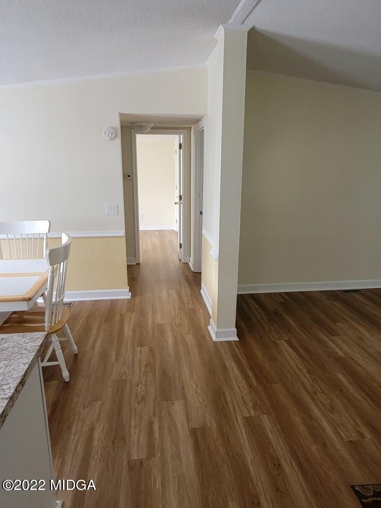4460 Fulton Mill Road Macon, GA 31216 - Photo 7 of 23 a view of room with wooden floor and chair
