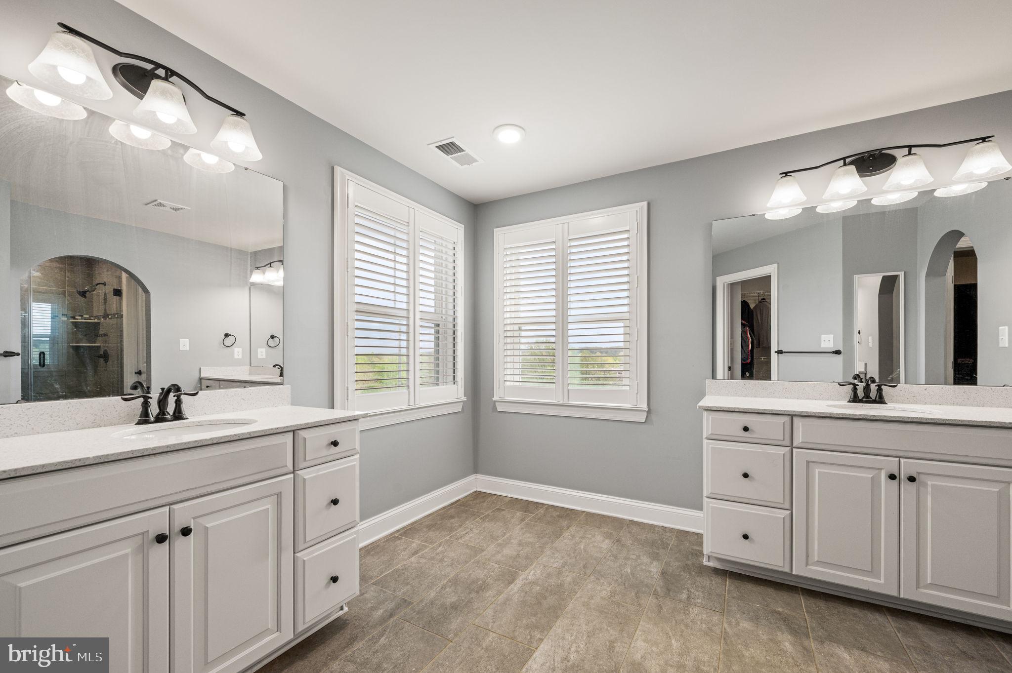 612 Quarry Point Road Malvern, PA 19355 - Photo 29 of 44 a spacious bathroom with a granite countertop sink mirror and next to a window