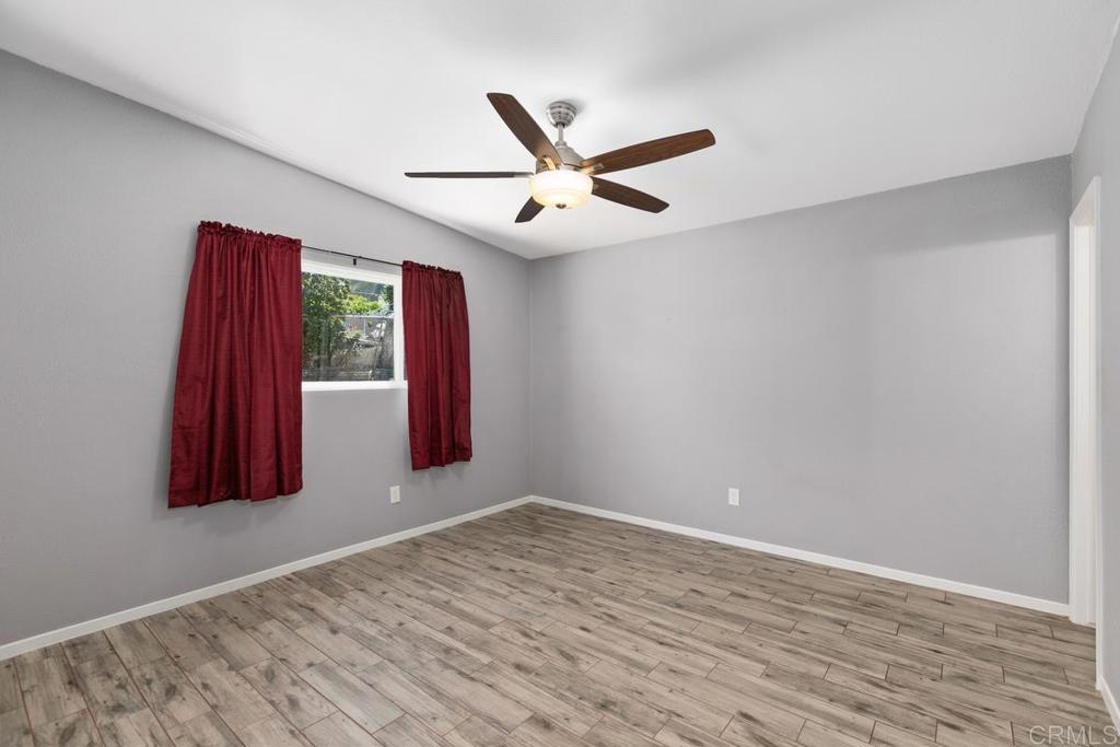 1451 Gowin Street Spring Valley, CA 91977 - Photo 14 of 24 an empty room with windows and fan
