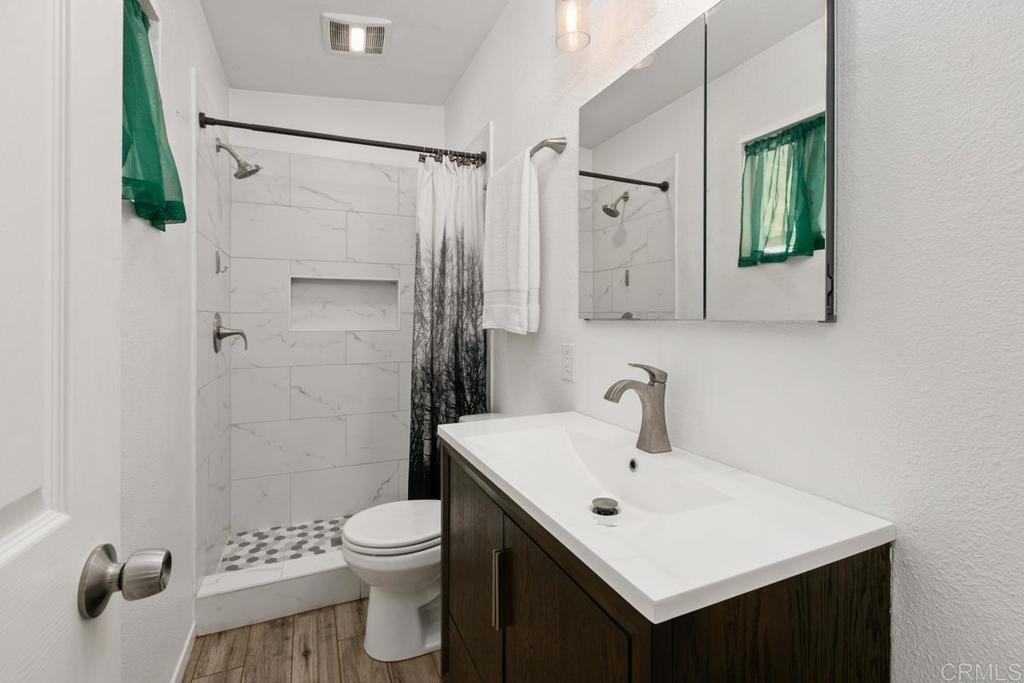 1451 Gowin Street Spring Valley, CA 91977 - Photo 16 of 24 a bathroom with a sink a toilet and shower