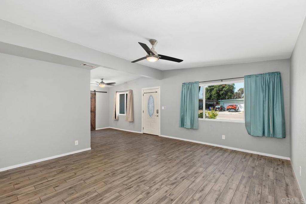1451 Gowin Street Spring Valley, CA 91977 - Photo 4 of 24 wooden floor in an empty room with a window