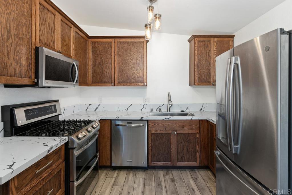 1451 Gowin Street Spring Valley, CA 91977 - Photo 8 of 24 a kitchen with stainless steel appliances a sink stove and refrigerator