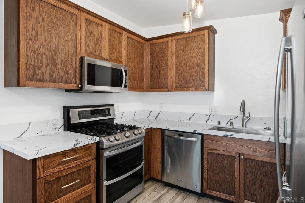 1451 Gowin Street Spring Valley, CA 91977 - Photo 10 of 24 a kitchen with a sink stove and microwave