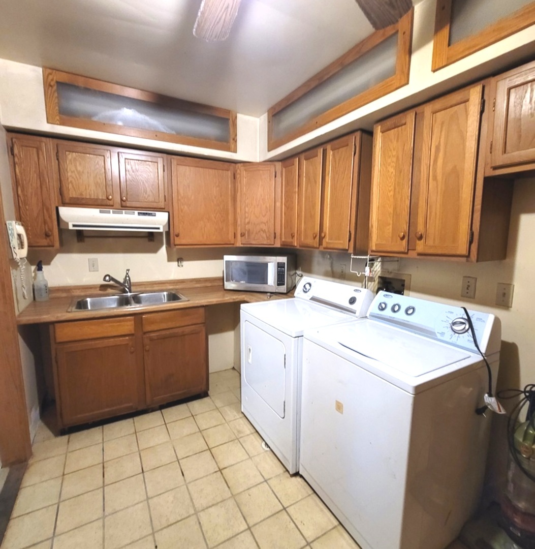 2166 Maple Road Homewood, IL 60430 - Photo 8 of 13 a kitchen with a sink a stove cabinets and a dining table