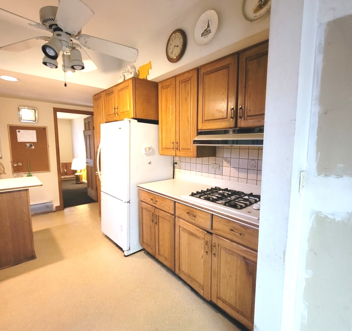 2166 Maple Road Homewood, IL 60430 - Photo 9 of 13 a stove top oven sitting inside of a kitchen
