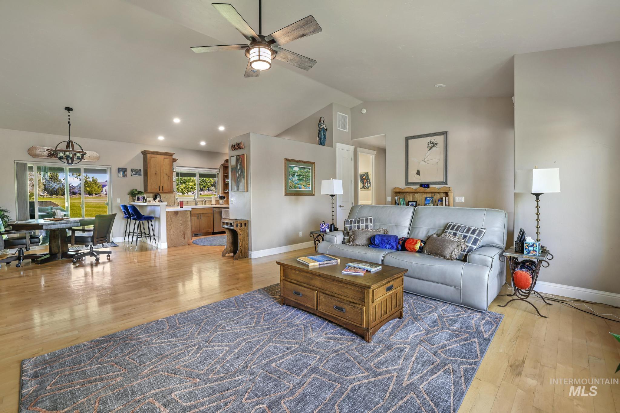 100 Olympic Road Jerome, ID 83338 - Photo 11 of 50 Spacious living area featuring vaulted ceilings, wood-finish flooring, recessed lighting, and a prominent ceiling fan