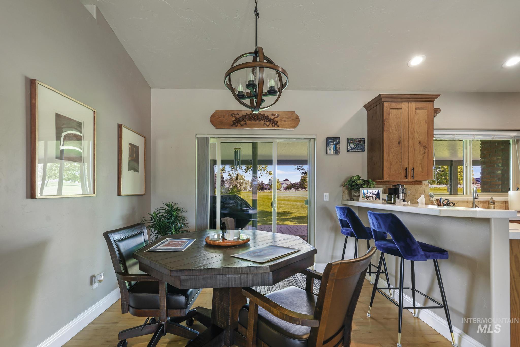 100 Olympic Road Jerome, ID 83338 - Photo 13 of 50 Dining area featuring wood-finish flooring and a contemporary spherical chandelier