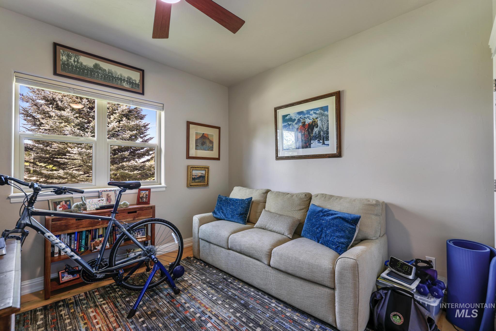 100 Olympic Road Jerome, ID 83338 - Photo 25 of 50 Room featuring a double window, wood-finish flooring, a ceiling fan, and light-toned walls
