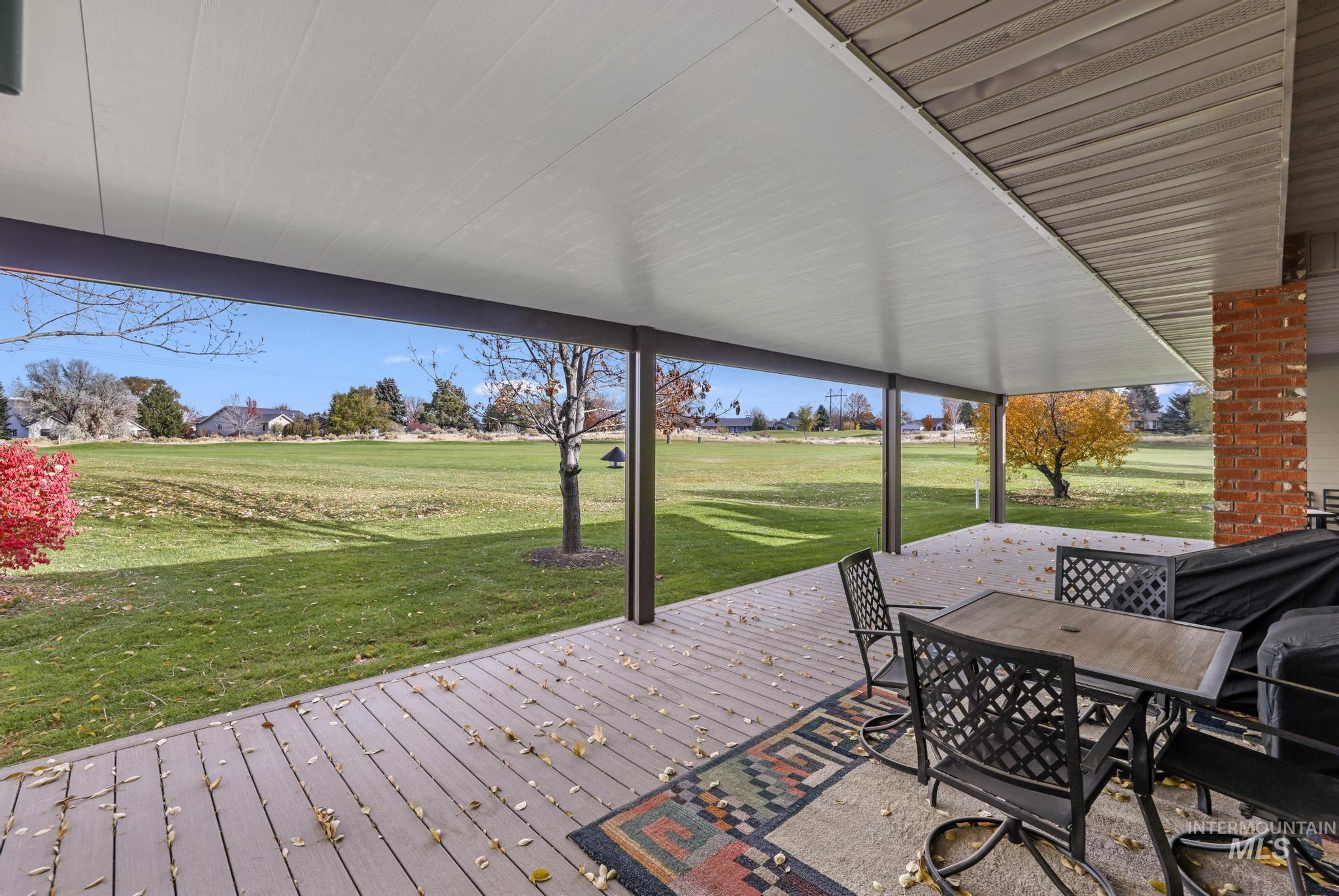 100 Olympic Road Jerome, ID 83338 - Photo 32 of 50 Expansive covered patio featuring wood-finish decking, structural support columns, and an exterior brick column