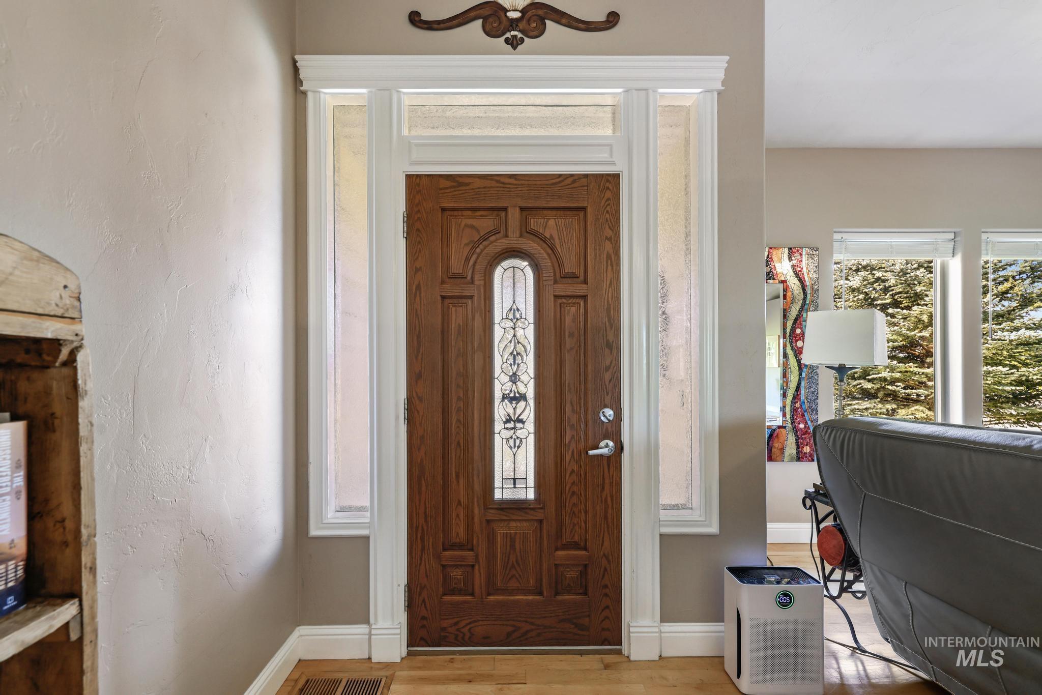 100 Olympic Road Jerome, ID 83338 - Photo 8 of 50 Entryway featuring a wood-panel door with decorative glass inserts