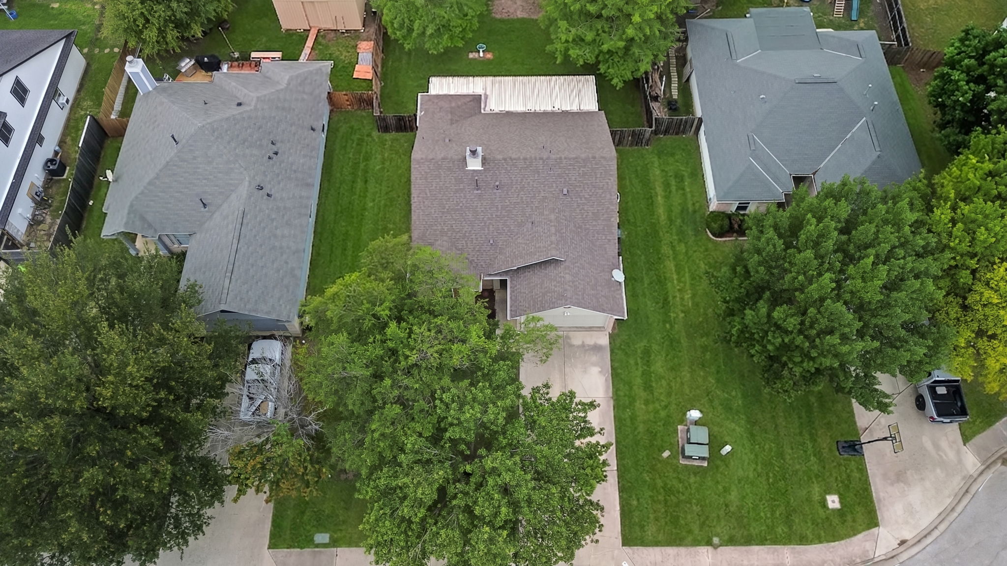 290 Bailey Loop Kyle, TX 78640 - Photo 32 of 33 Aerial perspective highlighting a residential property with a gabled roof and a spacious backyard