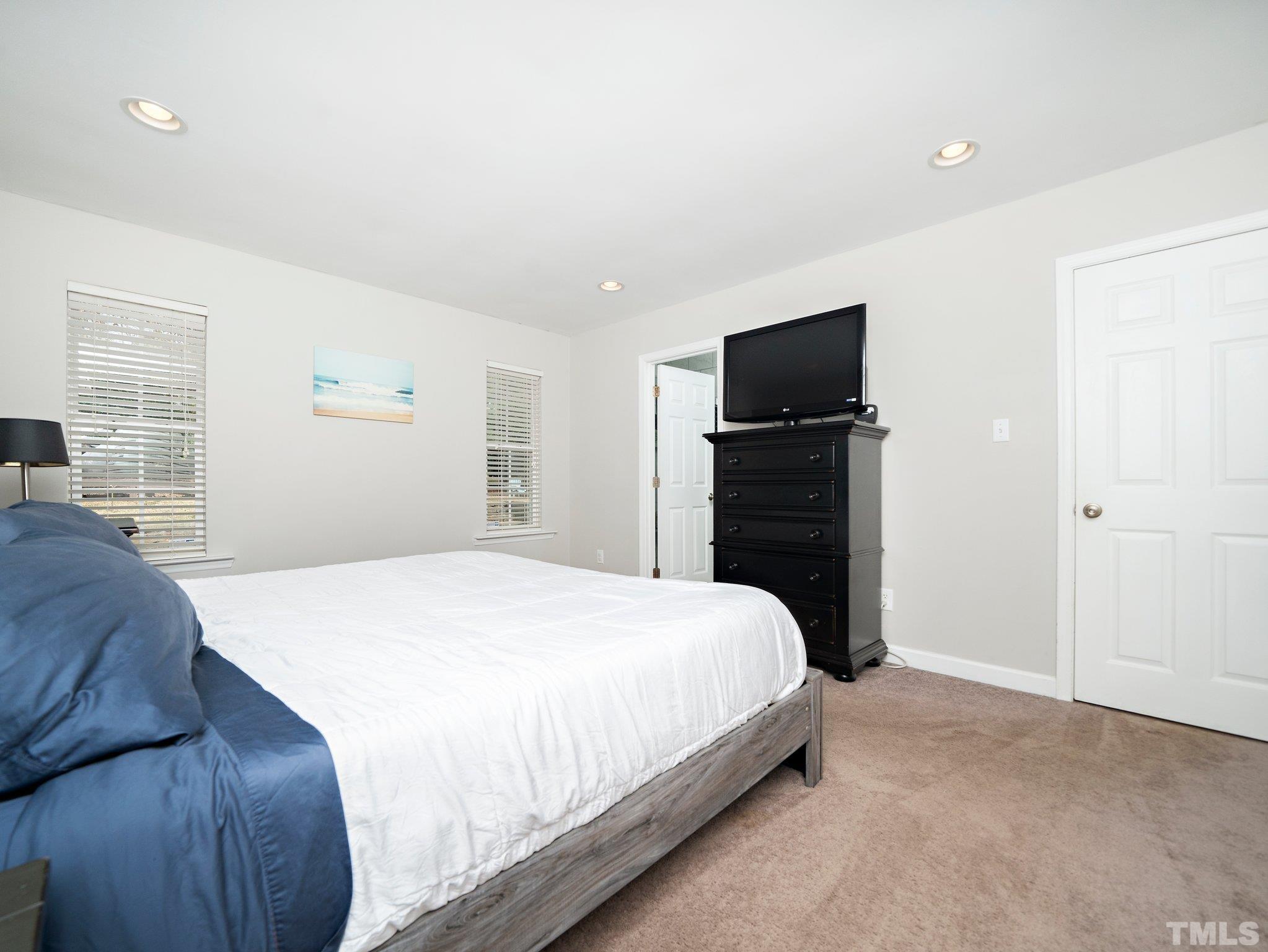 5433 Old Towne Road Raleigh, NC 27612 - Photo 23 of 32 a bedroom with a bed and a flat screen tv