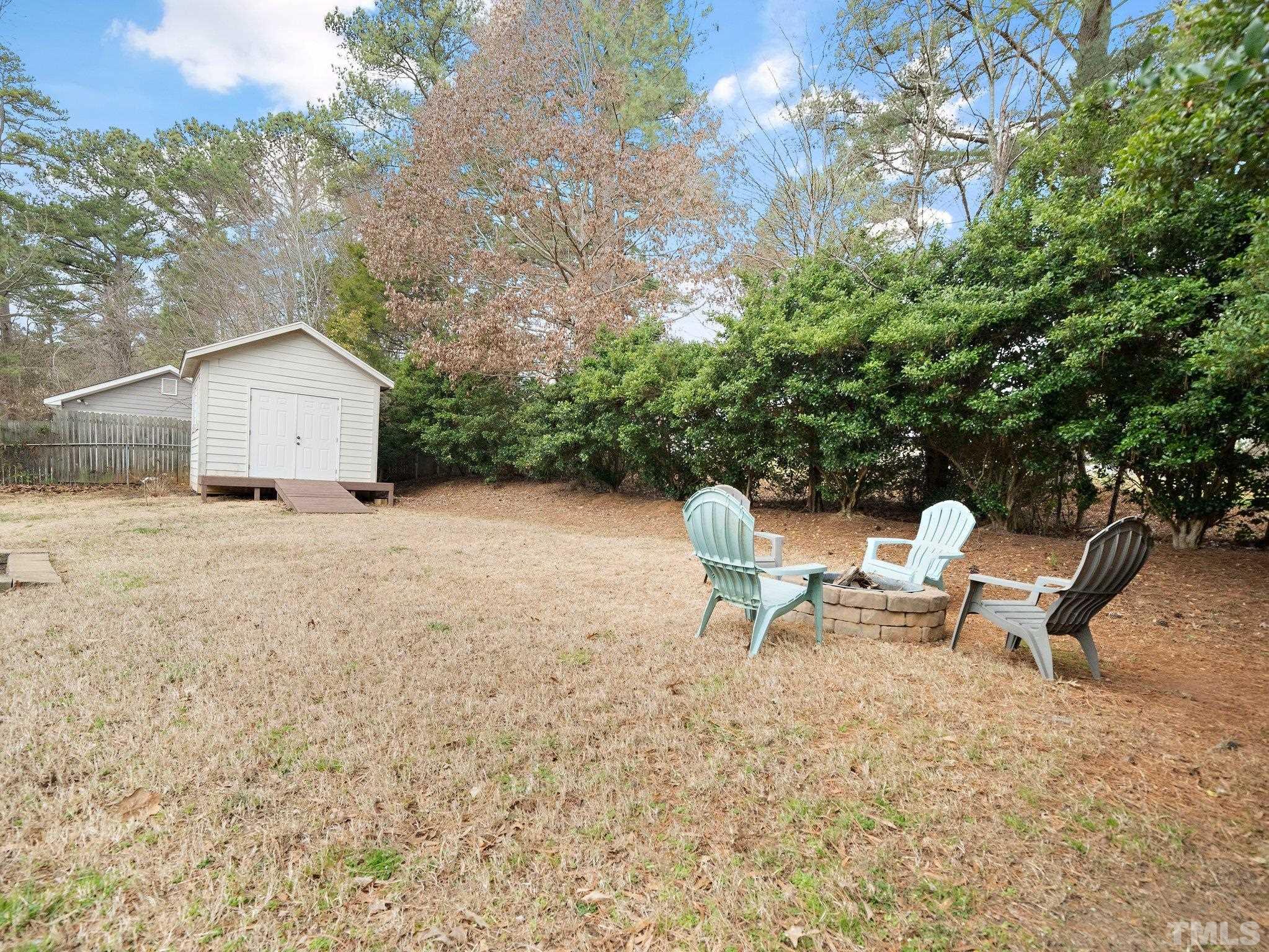 5433 Old Towne Road Raleigh, NC 27612 - Photo 28 of 32 a view of a backyard with a bench and some trees
