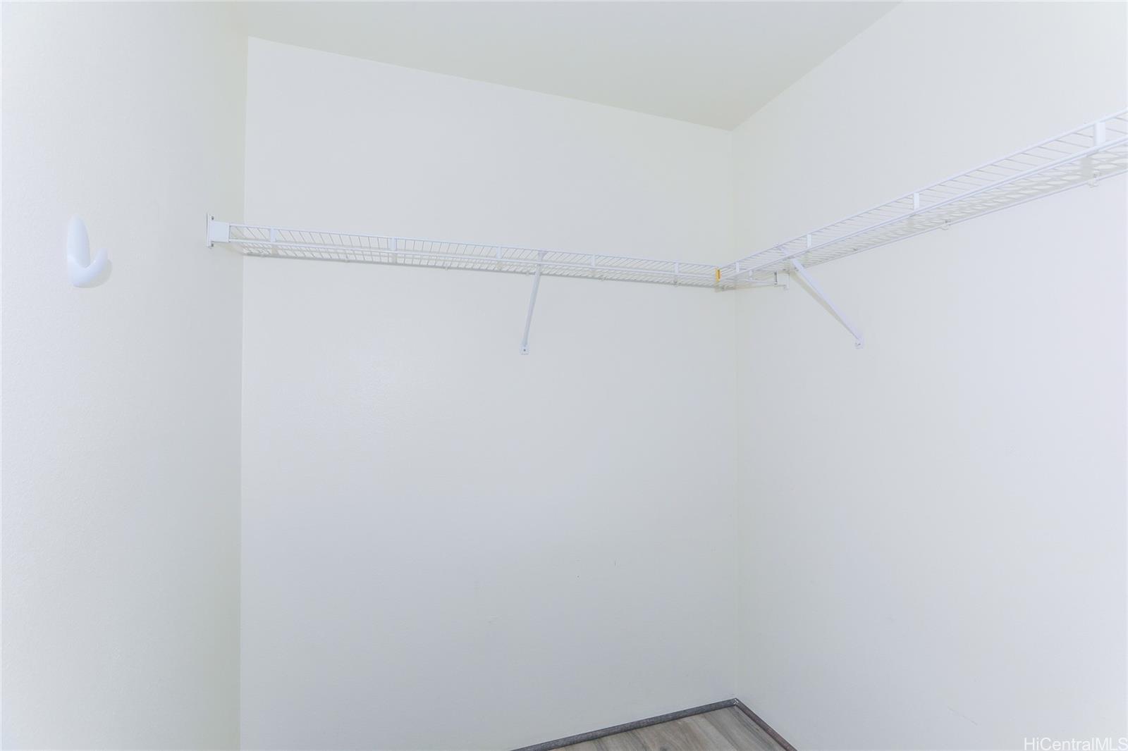 91-1011 Laulauna Street, Unit 136 Ewa Beach, HI 96706 - Photo 13 of 25 a view of a room with racks on the wall