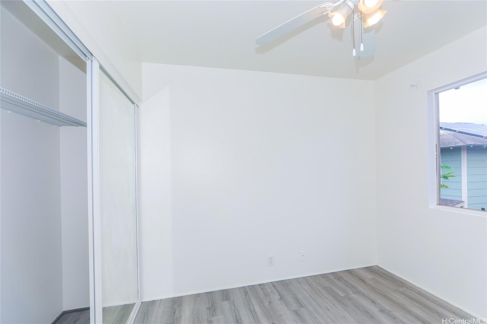 91-1011 Laulauna Street, Unit 136 Ewa Beach, HI 96706 - Photo 17 of 25 a view of small space with wooden floor and a window