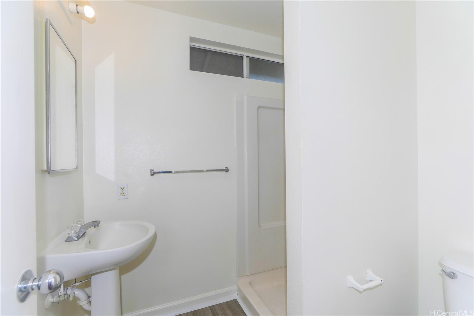 91-1011 Laulauna Street, Unit 136 Ewa Beach, HI 96706 - Photo 19 of 25 a bathroom with a sink and a mirror