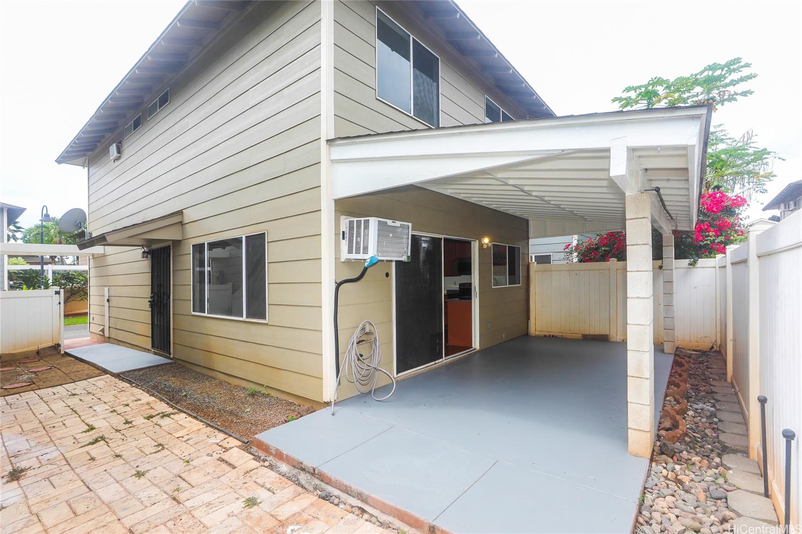 91-1011 Laulauna Street, Unit 136 Ewa Beach, HI 96706 - Photo 20 of 25 a view of a house with a porch