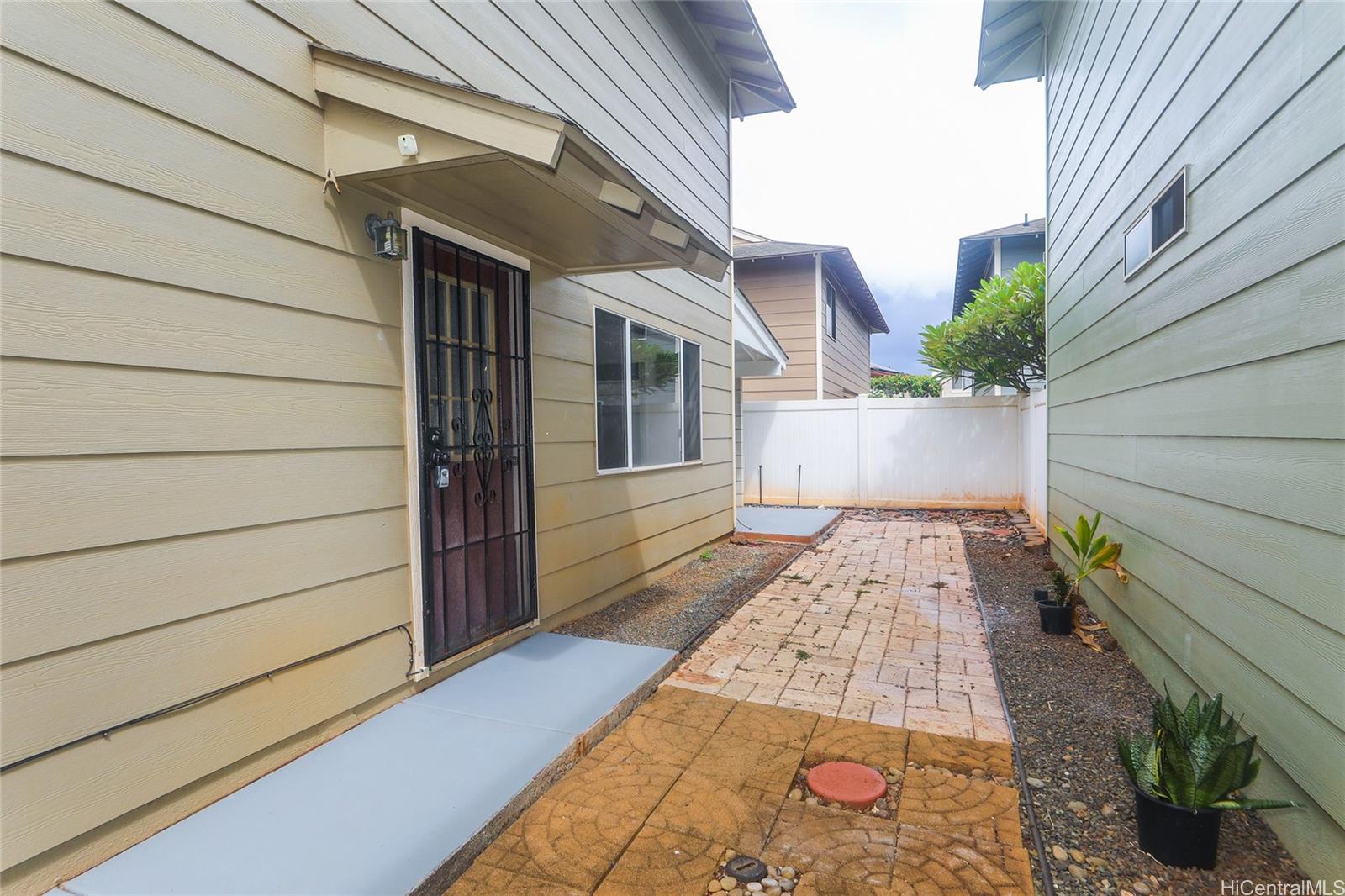 91-1011 Laulauna Street, Unit 136 Ewa Beach, HI 96706 - Photo 21 of 25 a view of a pathway with a house