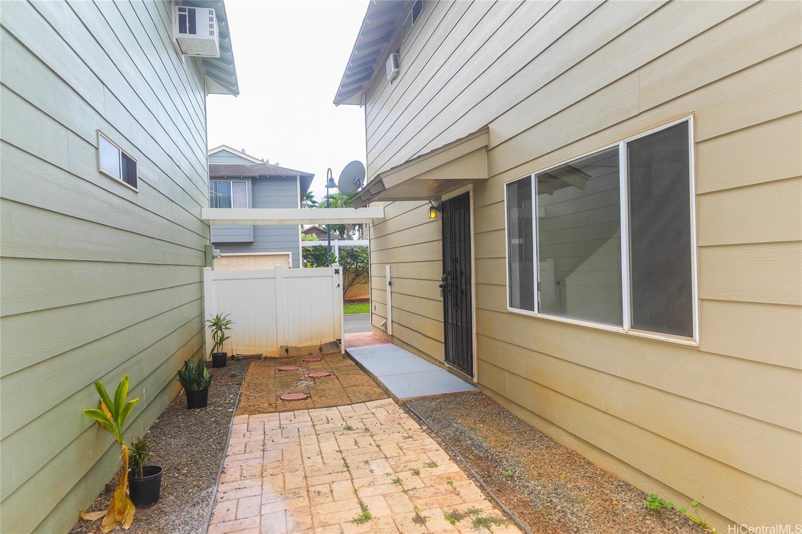 91-1011 Laulauna Street, Unit 136 Ewa Beach, HI 96706 - Photo 22 of 25 a view of a door and a window
