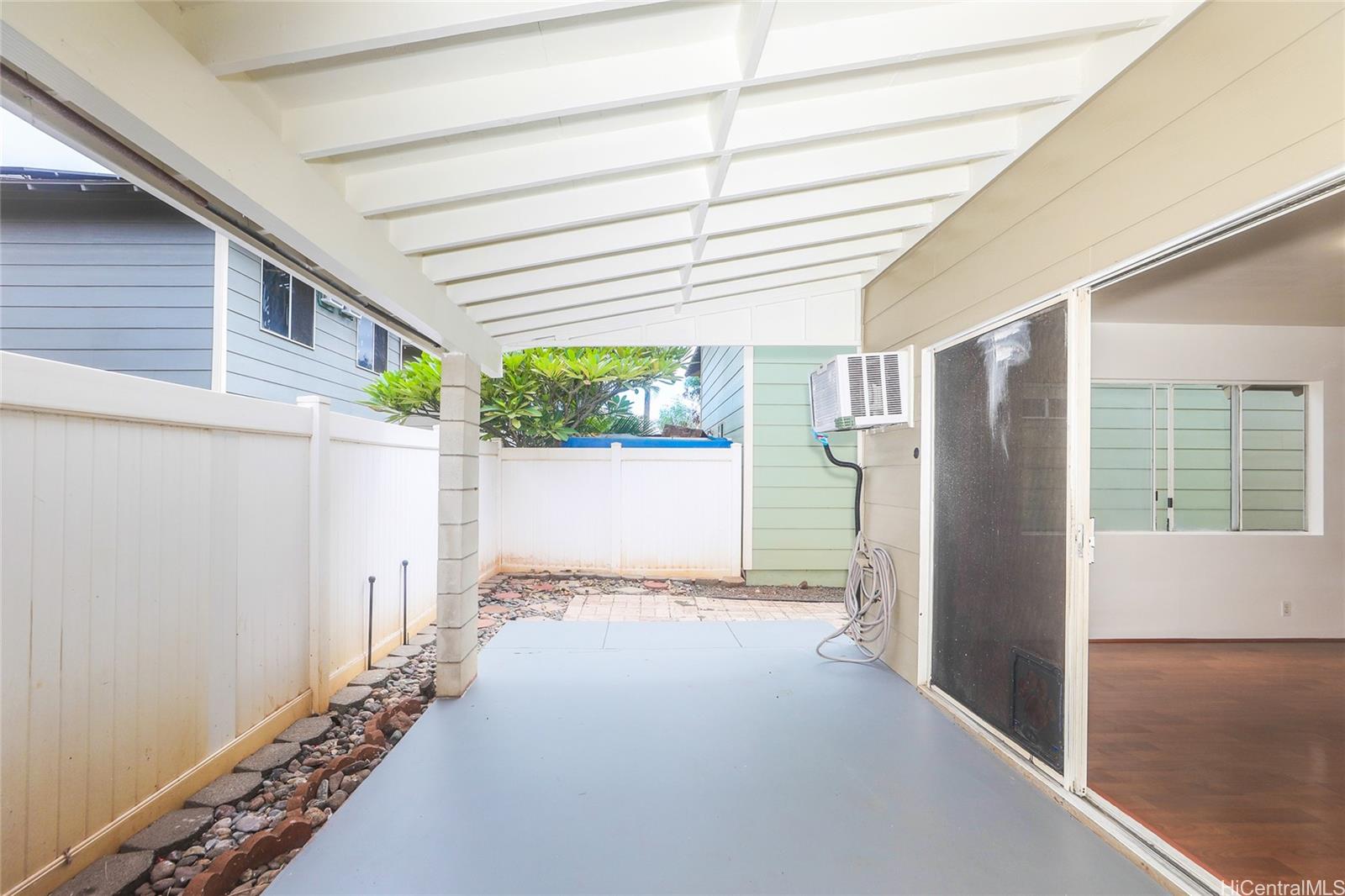 91-1011 Laulauna Street, Unit 136 Ewa Beach, HI 96706 - Photo 7 of 25 a view of a house with a garage
