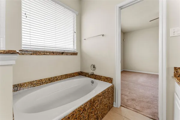 a bathroom with a bathtub and a window