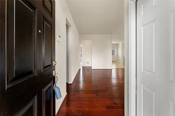 a view of hallway with wooden floor