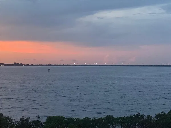 a view of lake with houses in background