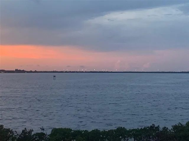 a view of lake with houses in background