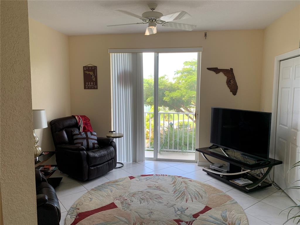 200 Harbor Walk Drive, Unit 321 Punta Gorda, FL 33950 - Photo 4 of 29 a bedroom with a bed and flat screen tv