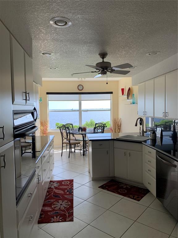 200 Harbor Walk Drive, Unit 321 Punta Gorda, FL 33950 - Photo 6 of 29 a kitchen with stainless steel appliances granite countertop a sink a stove and cabinets