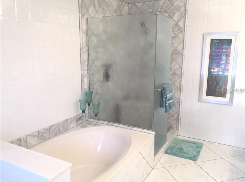 200 Harbor Walk Drive, Unit 321 Punta Gorda, FL 33950 - Photo 10 of 29 a bathroom with a tub shower and sink