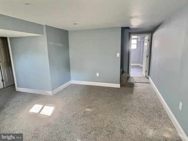 an empty room with windows and entrance